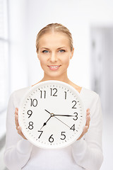 Image showing woman holding big clock