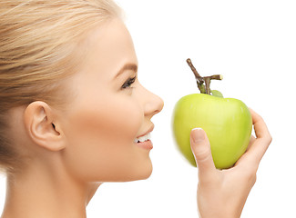 Image showing woman smelling apple