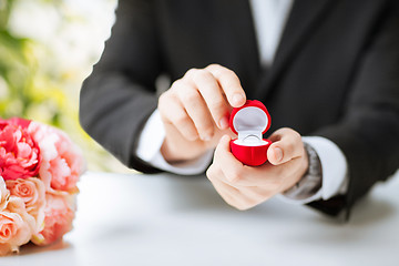 Image showing man with gift box and wedding ring