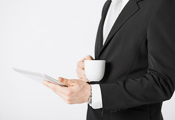 Image showing man with tablet pc and cup of coffee