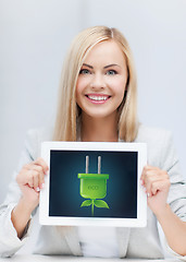Image showing woman with tablet pc with electrical eco plug