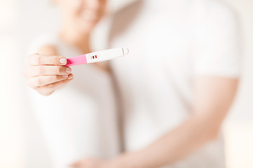 Image showing woman and man hands with pregnancy test