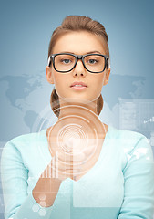 Image showing businesswoman pointing at virtual screen