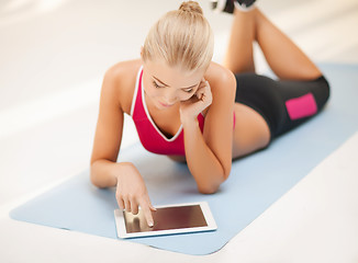 Image showing woman lying on the floor with tablet pc