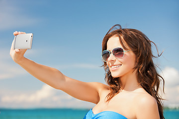 Image showing woman in bikini with phone