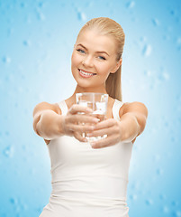 Image showing young smiling woman with glass of water