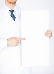 Image showing doctor holding blank white banner