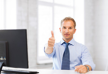 Image showing smiling businessman showing thumbs up