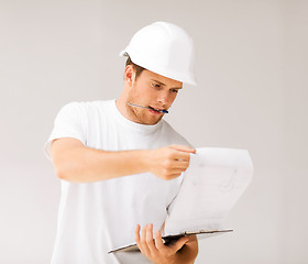 Image showing male architect looking at blueprint