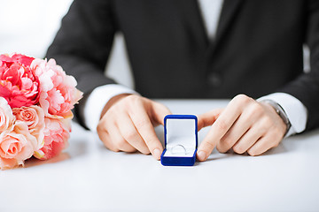 Image showing man with gift box and wedding ring