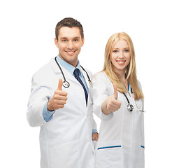 Image showing young team of two doctors showing thumbs up