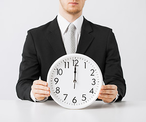 Image showing man with wall clock