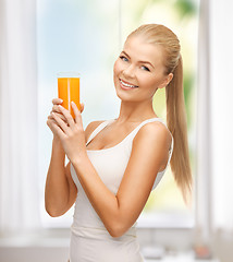 Image showing woman holding glass of orange juice