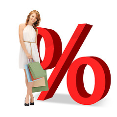 Image showing woman with shopping bags and percent signs