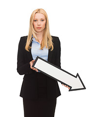 Image showing smiling businesswoman with direction arrow sign