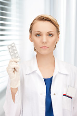 Image showing attractive female doctor with pills