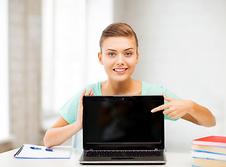 Image showing smiling student girl with laptop at school