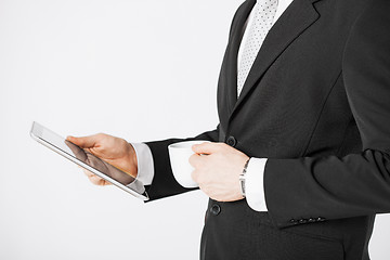 Image showing man with tablet pc and cup of coffee