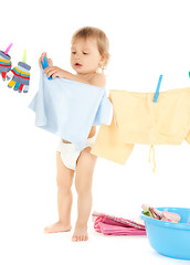 Image showing baby doing laundry