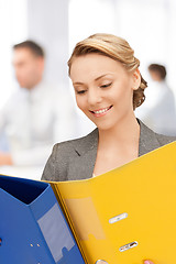 Image showing young attractive businesswoman with folders