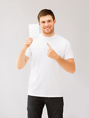 Image showing man pointing at blank white paper