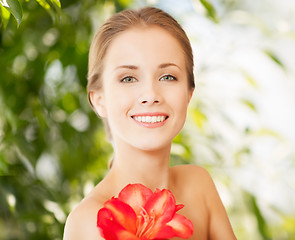 Image showing beautiful woman with red lily flower