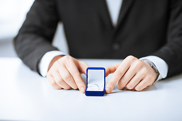 Image showing man with gift box and wedding ring