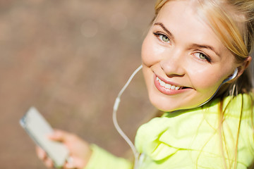 Image showing woman listening to music outdoors