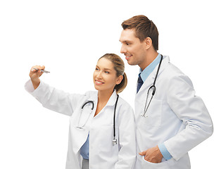 Image showing young doctors working with something imaginary