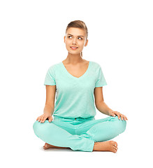 Image showing girl sitting in lotus position and meditating