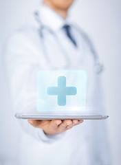 Image showing male doctor holding tablet pc with medical app