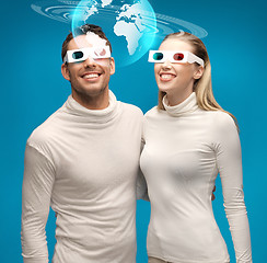 Image showing woman and man in 3d glasses looking at globe model
