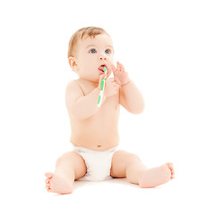 Image showing curious baby brushing teeth