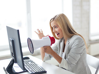 Image showing crazy businesswoman shouting in megaphone