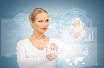 Image showing businesswoman touching virtual screen