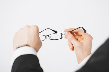 Image showing man hands holding eyeglasses