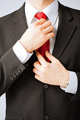 Image showing man adjusting his tie