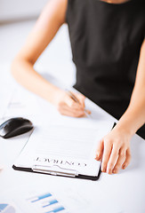 Image showing woman hand signing contract paper