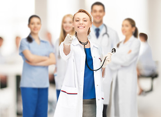 Image showing attractive female doctor pointing her finger