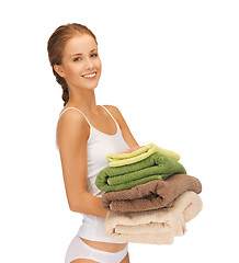 Image showing lovely housewife with towels