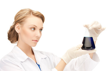 Image showing female chemist holding bulb with chemicals