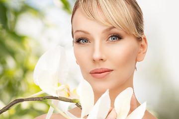 Image showing beautiful woman with orchid flower