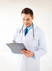 Image showing male doctor writing prescription