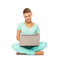 Image showing young girl sitting on the floor with laptop