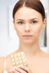 Image showing young beautiful woman with pills