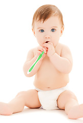 Image showing curious baby brushing teeth