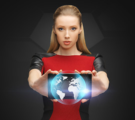 Image showing woman holding tablet pc with sign of globe
