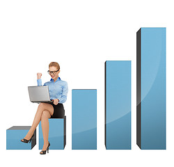 Image showing businesswoman sitting on big 3d chart