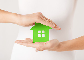 Image showing woman hands holding green house