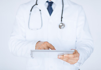 Image showing male doctor holding tablet pc